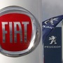 FILE PHOTO: The logos of car manufacturers Fiat and Peugeot are seen in front of dealerships of the companies in Saint-Nazaire, France, November 8, 2019. REUTERS/Stephane Mahe