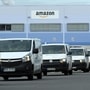 Delivery vehicles leaving an Amazon logistics centre.
