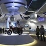 Visitors walk at TVS motorcycle pavilion at an auto expo in New Delhi January 6, 2010. REUTERS/Adnan Abidi/Files