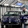 FILE PHOTO: A worker makes final checks on an e-Golf electric car at the new production line of the Transparent Factory of German carmaker Volkswagen in Dresden, Germany, March 30, 2017. REUTERS/Fabrizio Bensch