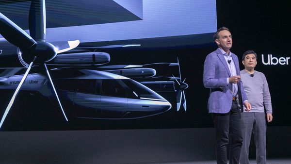 Eric Allison (L), Head of Uber Elevate, and Jaiwon Shin, Head of Urban Air Mobility at Hyundai, talk about the S-A1 electric vertical takeoff and landing (eVTOL) aircraft at CES 2020. (AFP)