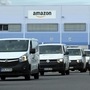 Delivery vehicles leaving an Amazon logistics centre.
