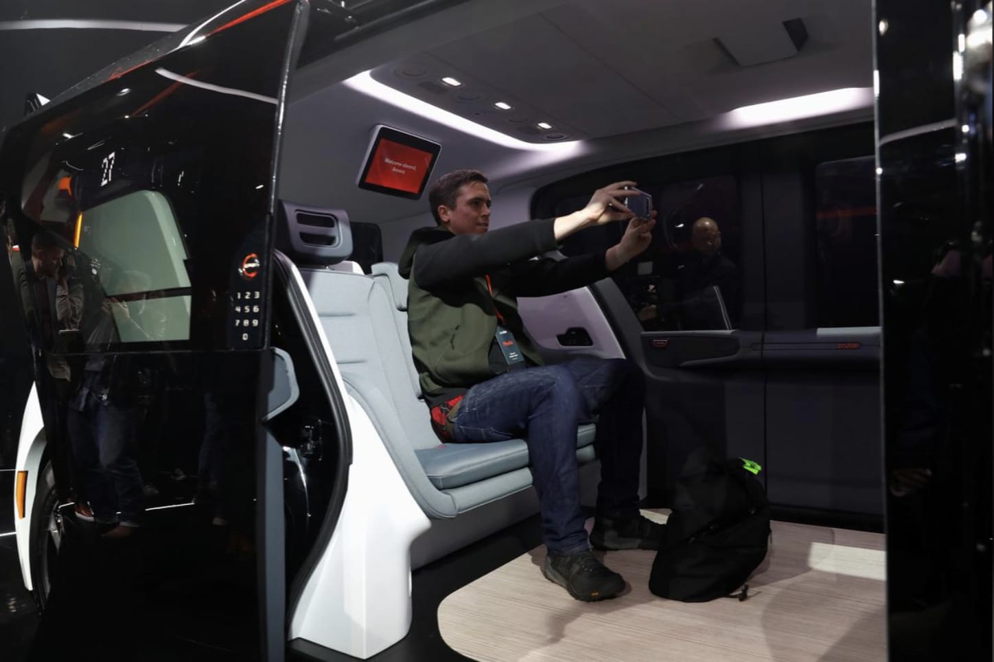 An attendee takes a selfie inside a Cruise Origin autonomous vehicle, a Honda and General Motors self-driving car partnership, during its unveiling in San Francisco, California, U.S. January 21, 2020. REUTERS/Stephen Lam
