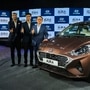 Hyundai Motors India MD & CEO SS Kim (R), Executive Director Sales and Marketing DH Park (C) and Director -Sale and Marketing Tarun Garg (L) pose for photographs with the newly launched sedan Hyundai Aura, in New Delhi, Tuesday, Jan. 21, 2020. (PTI Photo/Shahbaz Khan) (PTI)