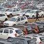FILE PHOTO: A worker walks past parked Renault cars at its stockyard on the outskirts of Ahmedabad June 11, 2013. REUTERS/Amit Dave