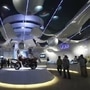 Visitors walk at TVS motorcycle pavilion at an auto expo in New Delhi January 6, 2010. REUTERS/Adnan Abidi/Files