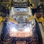 (FILES) In this file photo taken on November 12, 2014 Robots weld vehicle panels in the Body Shop at the Nissan Sunderland Plant in North East England. (Photo by Oli SCARFF / AFP) (AFP)
