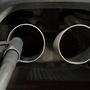 (FILES) This file photo taken on August 7, 2017 shows a hose for an emission test fixed in the exhaust pipe of a Volkswagen Golf 2,0 litre diesel car at the Technical Inspection Agency in Ludwigsburg, southwestern Germany. (Photo by THOMAS KIENZLE / AFP) (AFP)