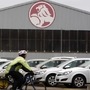 A cyclist rides past a General Motors (GM) Holden storage facility in Melbourne June 2, 2009. REUTERS/Mick Tsikas