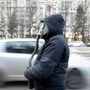 Cars drive by a man wearing a vintage gas mask during a climate and anti-pollution protest in Bucharest, Romania. (AP)