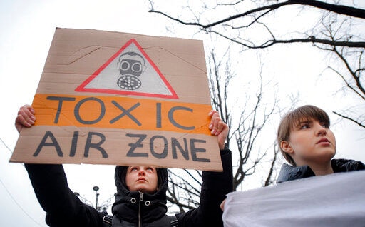 A girl holds a banner during a climate and anti-pollution protest in Bucharest, Romania.
