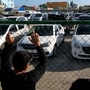People gather outside a government lot where used cars are for sale, in Havana, Cuba. (REUTERS)