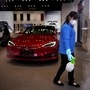 A worker sanitises a Tesla showroom, in a Shanghai shopping complex, as the country is hit by an outbreak of the novel coronavirus, Shanghai, China. (REUTERS)