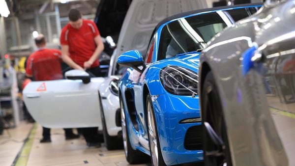A blue Porsche 718 Cayman luxury automobile stands following inspection on the production line inside the Porsche AG factory in Stuttgart, Germany. (Bloomberg)