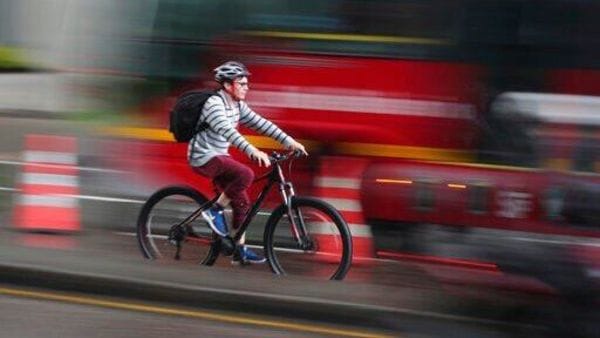 A man rides his bicycle in Bogota, Colombia, Monday, March 16, 2020. Officials in Colombia’s capital have expanded bike routes, encouraging people to abandon crowded public transportation and the risk of catching the coronavirus. The vast majority of people recover from the new virus. (AP Photo/Fernando Vergara)