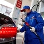 FILE PHOTO: A pump attendant wears a mask as he refuels a car at a Sinopec gas station where customers can buy supplies as the country is hit by an outbreak of the novel coronavirus, in Beijing, China, February 28, 2020. REUTERS/Thomas Peter/File Photo (REUTERS)