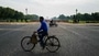 Commuters ride on a deserted Rajpath leading to India Gate during a government-imposed lockdown as a preventive measure against the COVID-19 in New Delhi on March 24, 2020. (AFP)