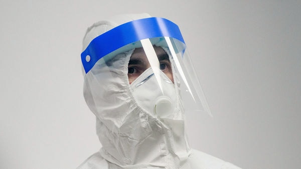 A health worker in a hazmat suit wears a face mask and facial visor at the Caraiman Multifunctional medical centre in Bucharest, Romania. (Bloomberg)