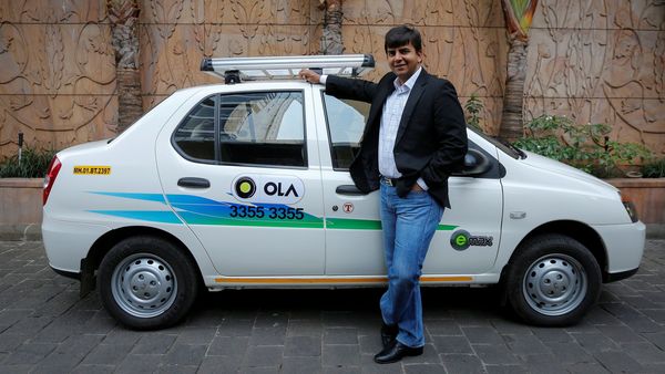 FILE PHOTO: Bhavish Aggarwal, CEO and co-founder of Ola, an app-based cab service provider, poses in front of an Ola cab in Mumbai. (REUTERS)
