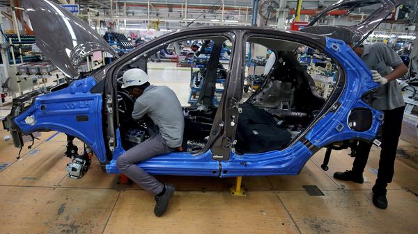 FILE PHOTO: Workers assemble a Tata Tiago car inside the Tata Motors car plant in Sanand, on the outskirts of Ahmedabad. (REUTERS)