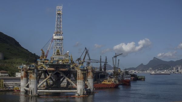 File photo: An idle oil rig sits next to docked supply vessels at the Maua shipyard in Niteroi, Brazil. (Bloomberg)