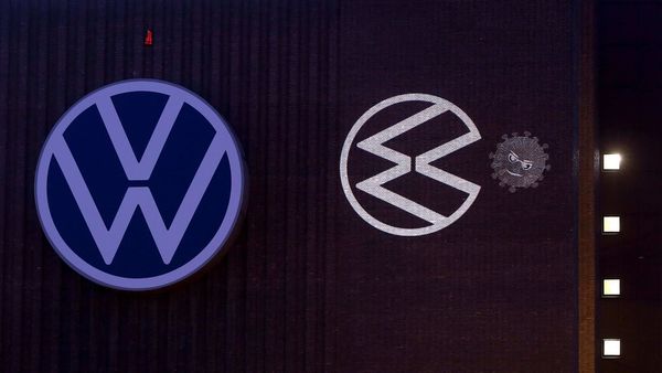 File photo: A coronavirus-eating VW logo is projected on the wall of the power plant at the headquarters of German car maker Volkswagen. (AFP)
