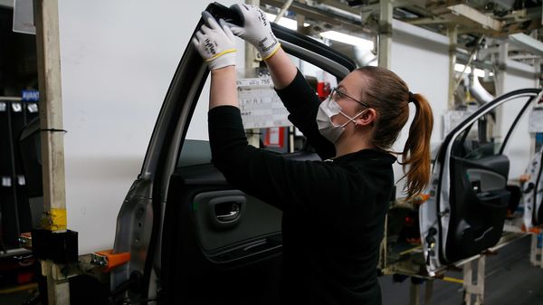 File photo: An employee wearing a face mask works on a door of a Yaris car at the Toyota car factory in Onnaing, northern France. (AP)