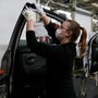 File photo: An employee wearing a face mask works on a door of a Yaris car at the Toyota car factory in Onnaing, northern France. (AP)