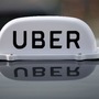 File photo: The Logo of taxi company Uber is seen on the roof of a private taxi.