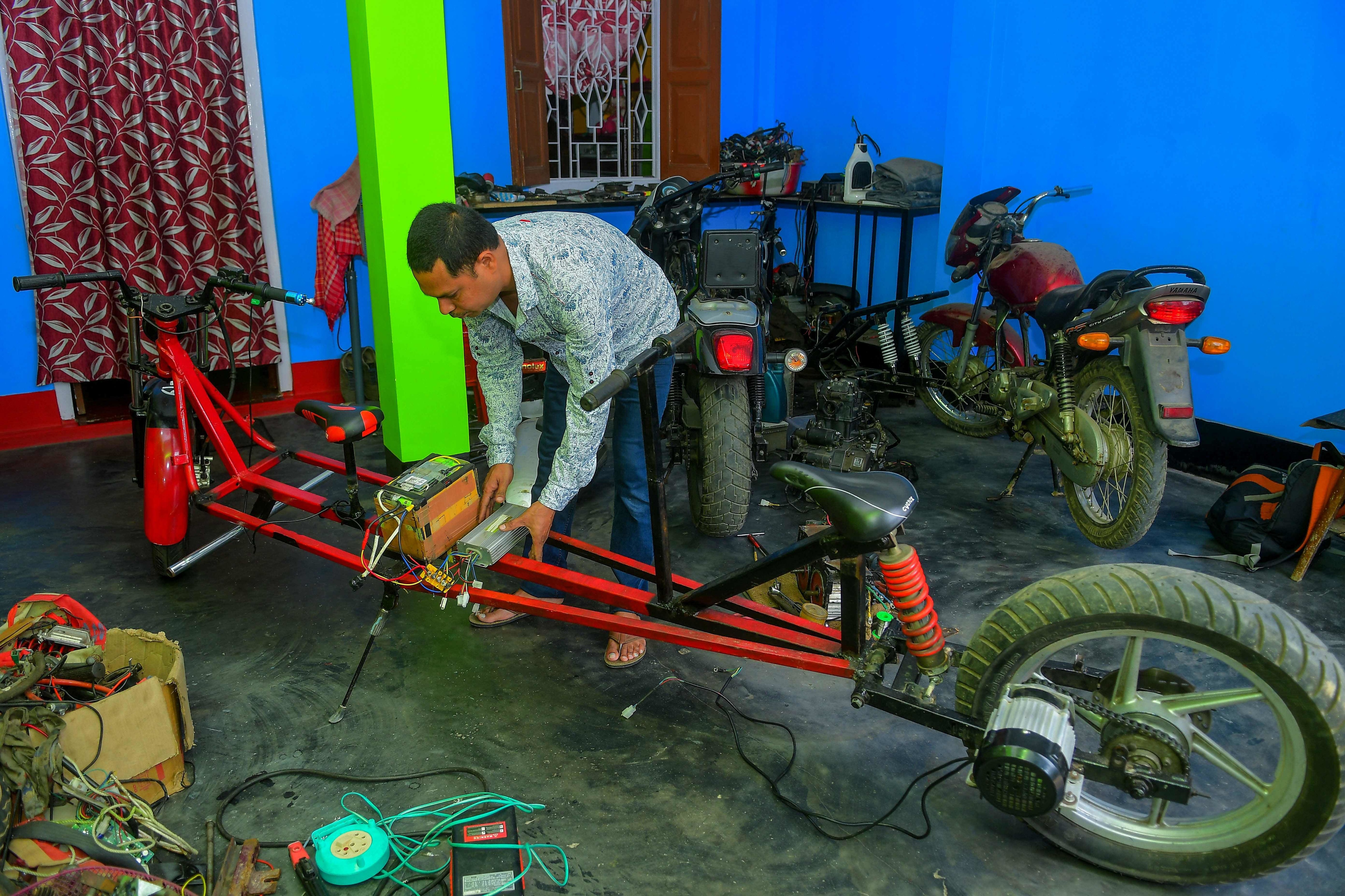 Partha Saha's bike runs on battery power, which takes 3 hours to charge.