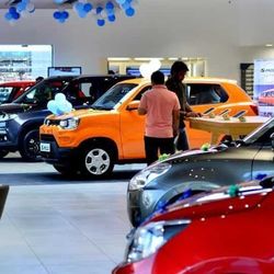 Customers check out car models at Maruti Suzuki Arena Showroom