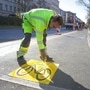 Employee Alexander of the Zeppelin company marks a temporary cycle lane on the Kottbusser Damm in Berlin, Germany, Wednesday, April 22, 2020. Due to the corona pandemic, the establishment of this bicycle lane was accelerated in order to give citizens an incentive to switch to the bicycle. The final installation of a cycle lane on Kottbusser Damm is planned for September 2020. (Joerg Carstensen/dpa via AP) (AP)