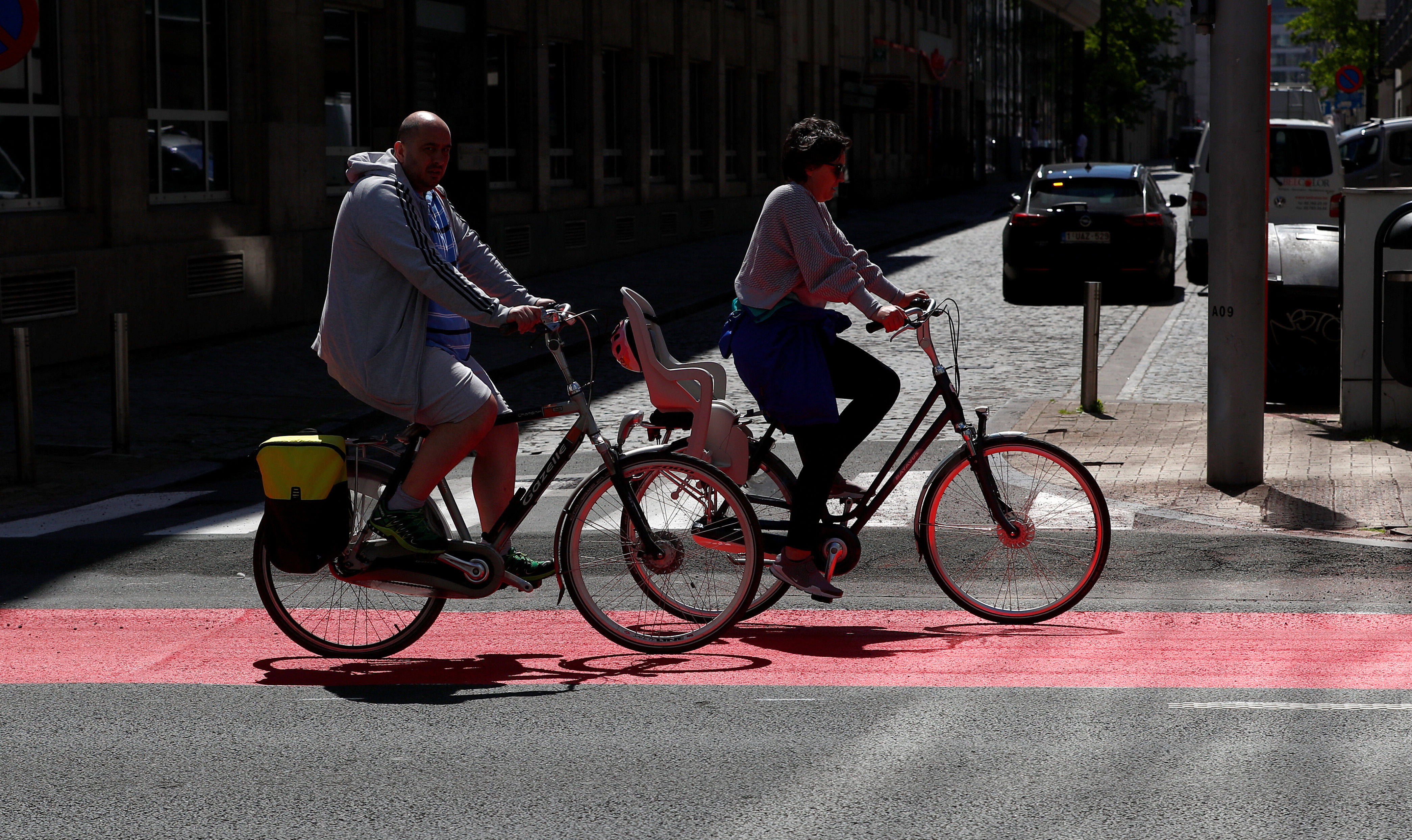 FILE PHOTO: People ride bicycles on a new cycling lane in central Brussel, amid the coronavirus disease outbreak in Brussels, Belgium.
