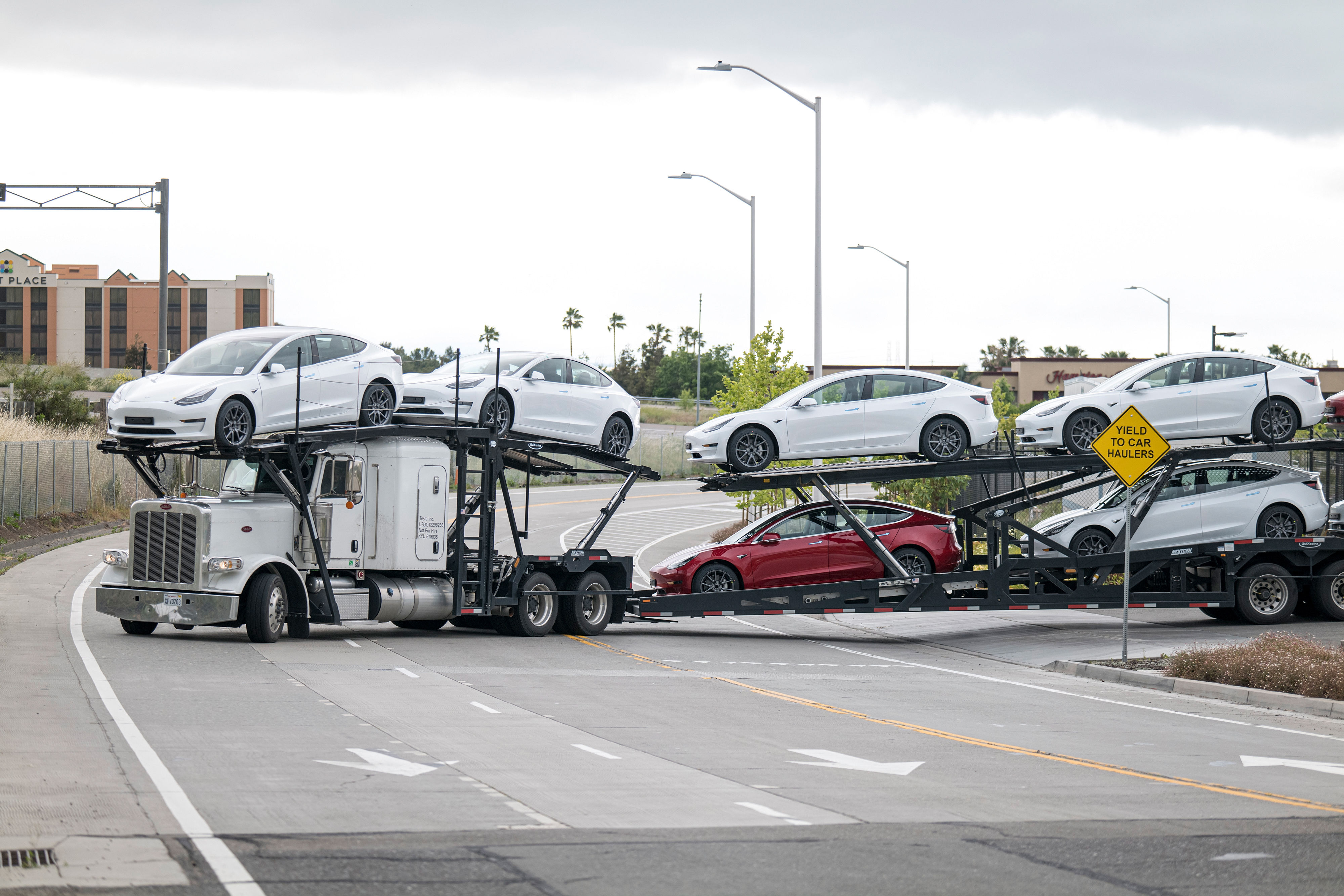 A car trailer carrying Tesla Inc. vehicles drives out of the company's assembly plant in Fremont, California, U.S., on Monday, May 11, 2020. A car trailer carrying Tesla Inc. vehicles drives out of the company's assembly plant in Fremont, California, U.S., on Monday, May 11, 2020.