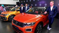 Volkswagen Passenger Cars' India Director, Steffen Knapp poses for photographs next to the T-Roc car during the unveiling event of three new SUVW(Sport Utility VolksWagen) models, Tiguan Allspace, T-Roc and Taigun, to customers. (AFP)