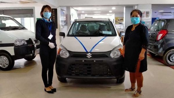 A customer receiving her new vehicle as showrooms gradually resume operations. (Photo courtesy: Maruti Suzuki)