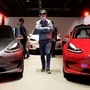 A man wearing a face mask following the coronavirus disease (COVID-19) outbreak walks by Tesla Model 3 sedans and Tesla Model X sport utility vehicle at a new Tesla showroom in Shanghai, China May 8, 2020. Picture taken May 8, 2020. REUTERS/Yilei Sun (REUTERS)