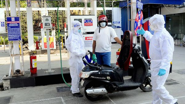 Petrol pump workers wear protective suit on duty during the nationwide Covid-19 lockdown in New Delhi. (ANI)