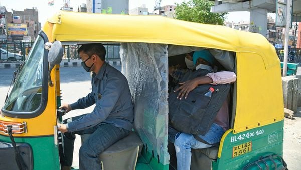 An auto rickshaw is seen with a plastic layer divider between passenger and driver side in New Delhi on Wednesday (May 19).