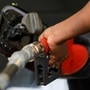 FILE PHOTO: A gas station attendant pumps fuel into a customer's car. (REUTERS)