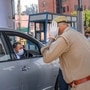 Noida: Police personnel check a commuter travelling from Delhi to Noida during the nationwide lockdown to curb the spread of coronavirus. (PTI)