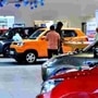 File photo: Customers check out car models at Maruti Suzuki Arena Showroom