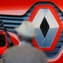 A customer looks at cars in front of a logo of Renault carmaker at a dealership in Nantes, France, May 26, 2020. (REUTERS)