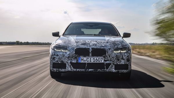 The BMW 4 Series Coupe draped in camouflage in action during testing.