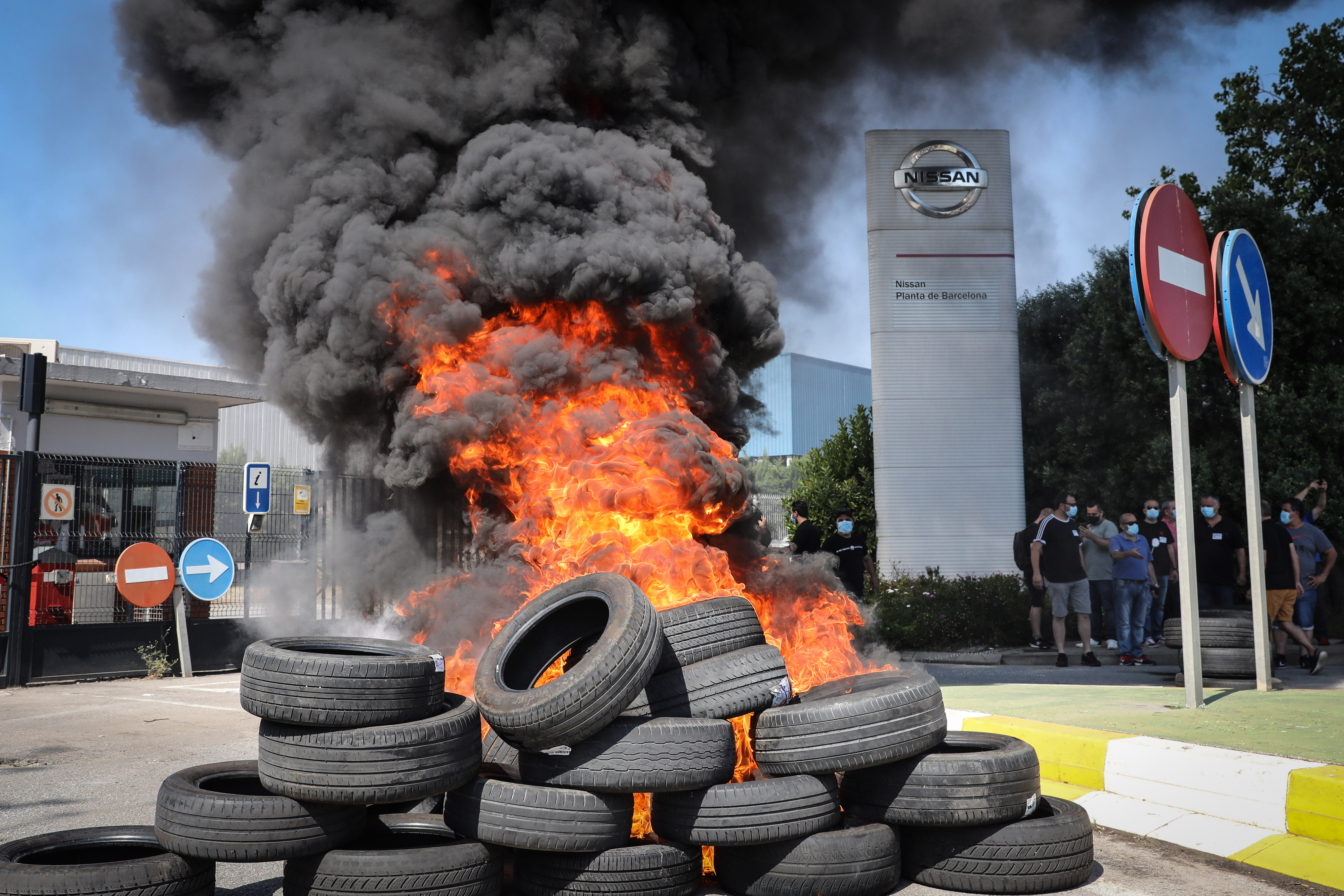 Demonstrators set fire to tires outside the Nissan Motor Co. plant in Barcelona.