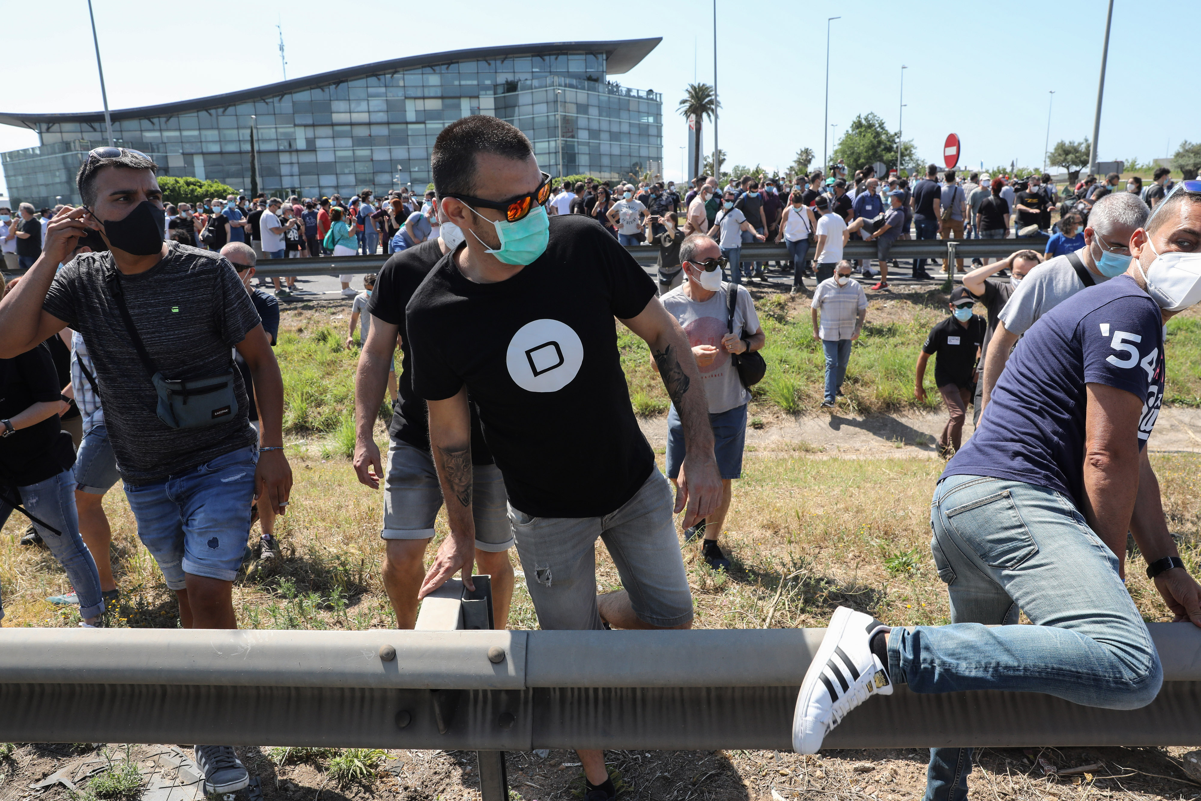 Demonstrators climbed over a barrier to block the Ronda del Litoral highway following a protest outside Nissan's Barcelona plant. The company's main plant in Barcelona employs about 2,400 workers with another 600 workers in several related facilities. Demonstrators climbed over a barrier to block the Ronda del Litoral highway following a protest outside Nissan's Barcelona plant. The company's main plant in Barcelona employs about 2,400 workers with another 600 workers in several related facilities.