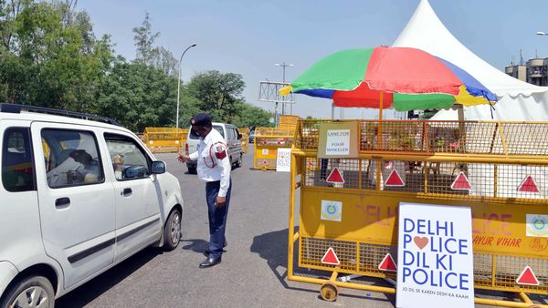 Police check vehicle at a checkpoint set up on road in Noida-Delhi Border during the nationwide lockdown.