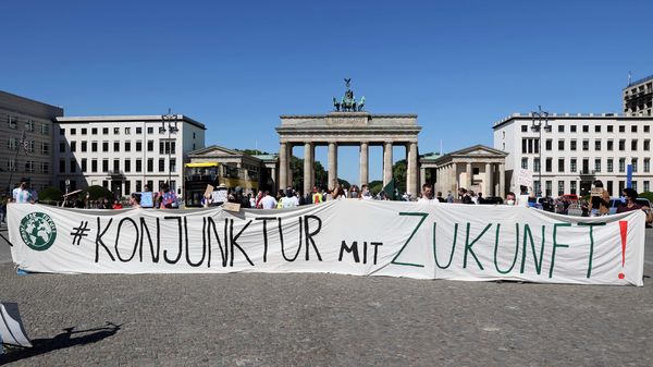 Protesters hold a banner reading "Economic activity with future!" during a demonstration against the planned state aid for Germany's automobile industry, amid the spread of the coronavirus disease (COVID-19), in front of the Brandenburg Gate in Berlin. (REUTERS)