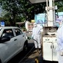 File photo: Petrol pump workers wear protective suit on duty during the nationwide lockdown in New Delhi. (ANI)