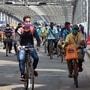 People ride bicycles to reach their workplace as unavailability of vehicles during coronavirus lockdown, at Howrah Bridge in Kolkata on Thursday. (ANI)